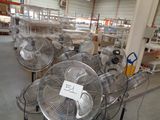 many fans that are on the floor in a warehouse