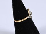 a close up of a gold ring with a diamond on it