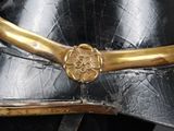 a close up of a helmet with a gold flower on it