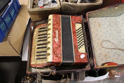 an old accordion sitting on a table next to other items