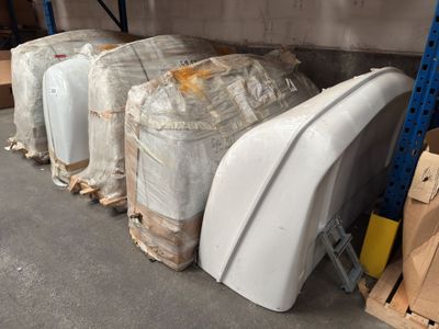 many pieces of luggage sitting on the floor in a warehouse