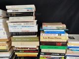 many books stacked on top of each other on a table