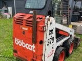 a picture of a bobcat ski - door parked in a yard