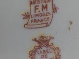 a white plate with a red and gold emblem on it