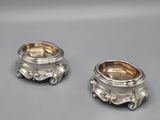 pair of silverplated bowls with handles and handles on a gray surface