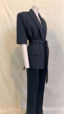 the suit is black and has a belt on the waist