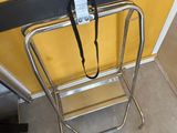 a person standing next to a luggage bag on a chair
