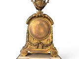 a gold clock with a crown on top of it