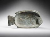an image of a fish shaped object sitting on top of a white surface