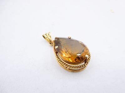 a close up of a pendant on a white surface