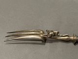a fork with a flower on it sitting on a table