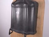 a metal container on a wooden shelf in a room