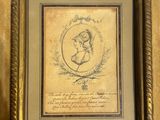 a framed picture of a woman holding a baby in her arms