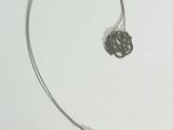 a picture of a silver necklace with a flower on it