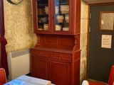 a dining room with a table, chairs, and a china cabinet