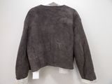 an image of a jacket hanging on a hanger on a wall