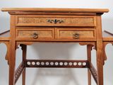 a small wooden desk with a drawer on top of it