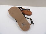 pair of women ' s black sandals on a white surface