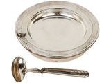 silver plate with spoon and spoon rest on a white background