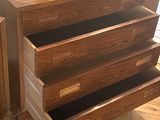a wooden dresser with three drawers and a mirror