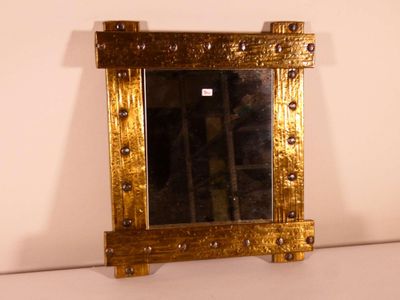 a mirror that is sitting on a shelf in a room