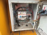 an old electrical box with wires and wires in it on a tiled floor