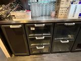a counter with a lot of bottles and glasses on it