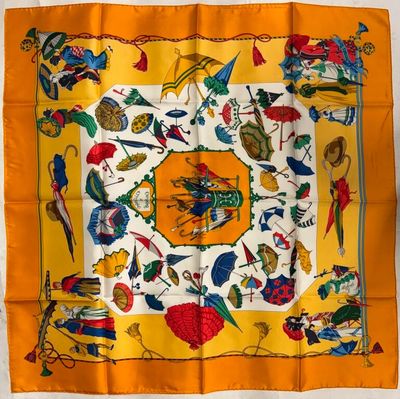 a yellow scarf with colorful birds and flowers on it