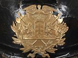 a black helmet with a gold emblem on it