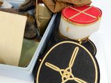 a box with a pair of boots, a hat, and other items in it