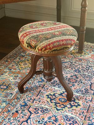 a small stool sitting on a rug in a room