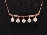 a gold necklace with pearls and diamonds on a mannequin mannequin mannequin mannequin mannequin mannequin mannequin manne