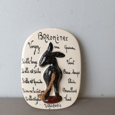 a ceramic plaque with a picture of a rabbit on it