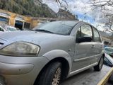 a silver car that is parked on the side of the road