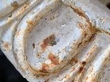 a close up of a rusted metal object on the ground