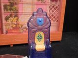 a small plastic bottle with a toothbrush and other items on a table