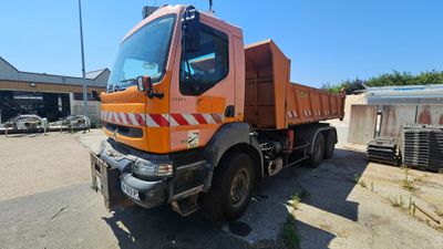 a large orange truck that is parked in a lot