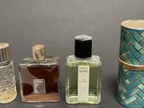three bottles of perfume sitting next to each other on a table
