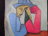 un tableau représentant un homme avec un chapeau posé sur une table