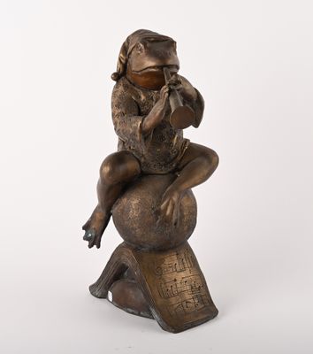 bronze statue of a woman sitting on a globe with a monkey on her back