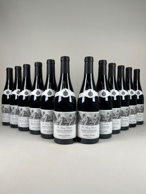 twelve bottles of wine lined up in a row on a table