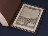 an open book with a drawing on it sitting on a table