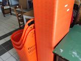 two orange bins sitting next to each other on the floor