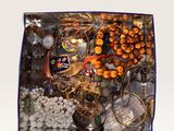 a picture of a box of jewelry on a white surface