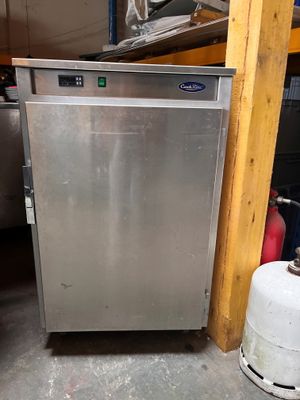 an image of a stainless steel refrigerator in a garage