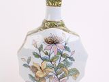 a vase with a floral design on it on a white background
