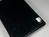 a black laptop computer sitting on a white table
