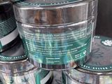 a stack of tins with labels on them sitting on a table