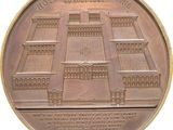 an image of a bronze medal with a picture of a building