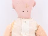 a small doll with a white shirt and white pants